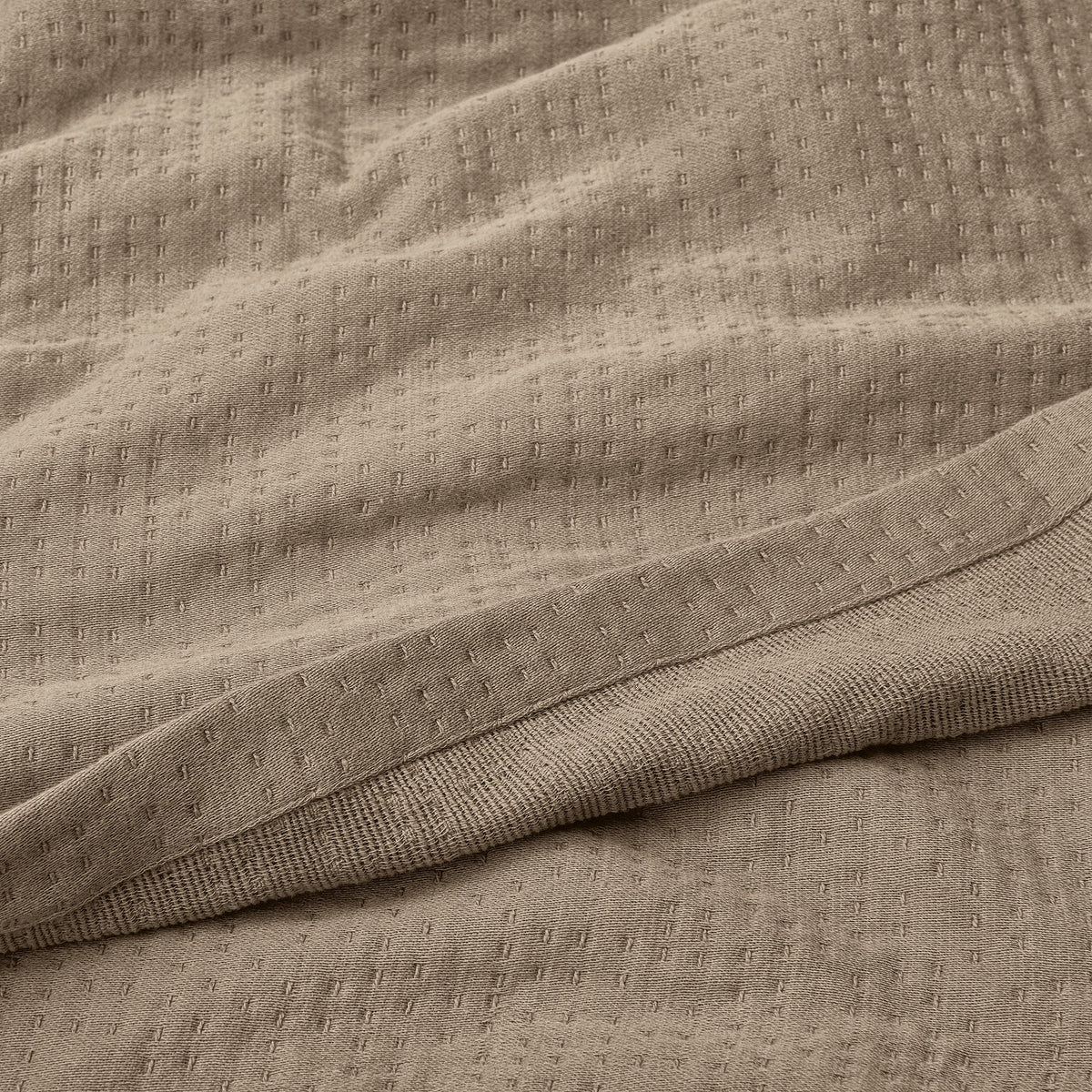 Texture Detail Of Organic Matelasse Blanket In Beige