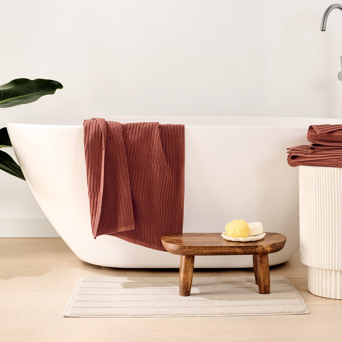 Organic Ribbed Towels In Copper Next to Bathtub