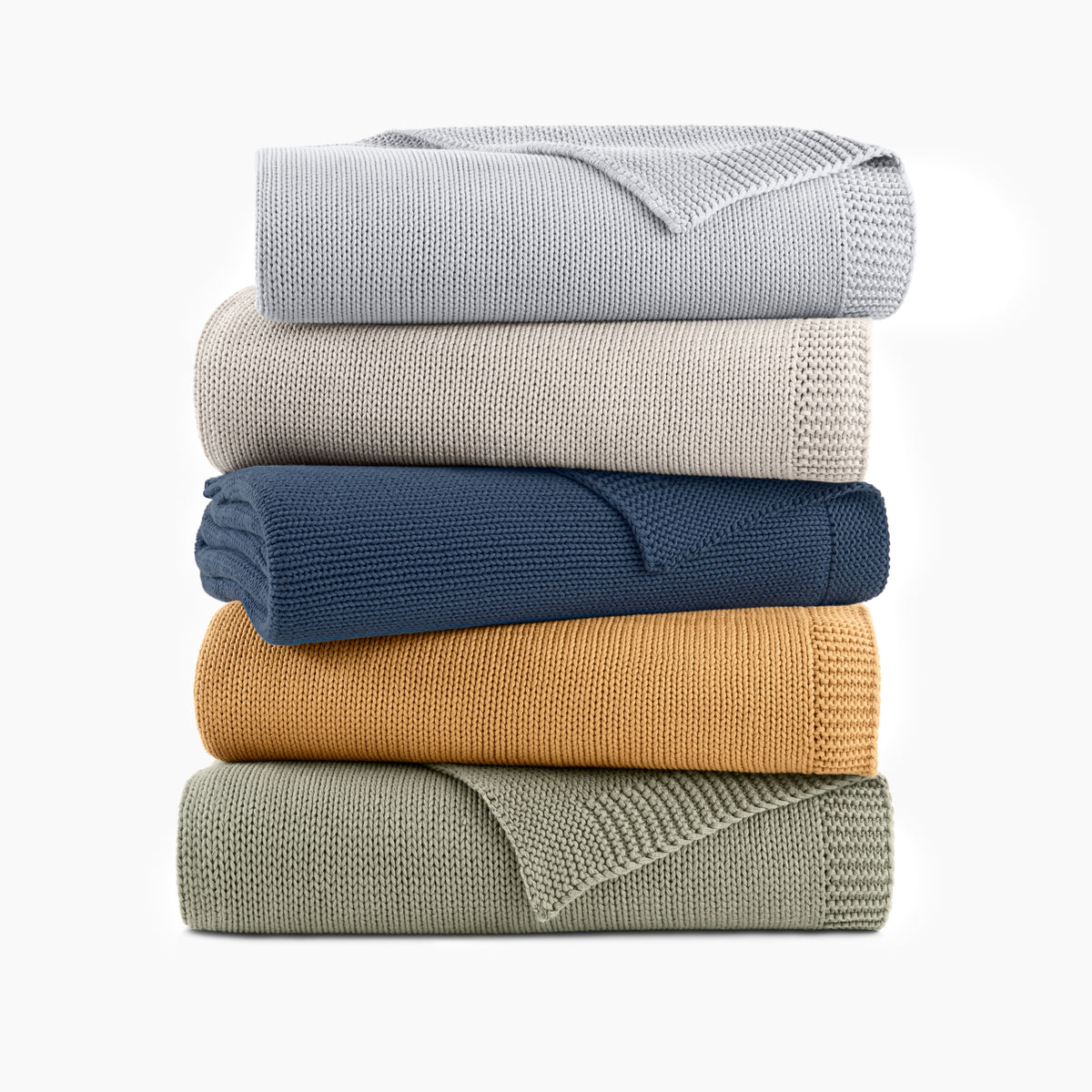 Stack Of Organic Cotton Chunky Knit Throws In All Available Colors