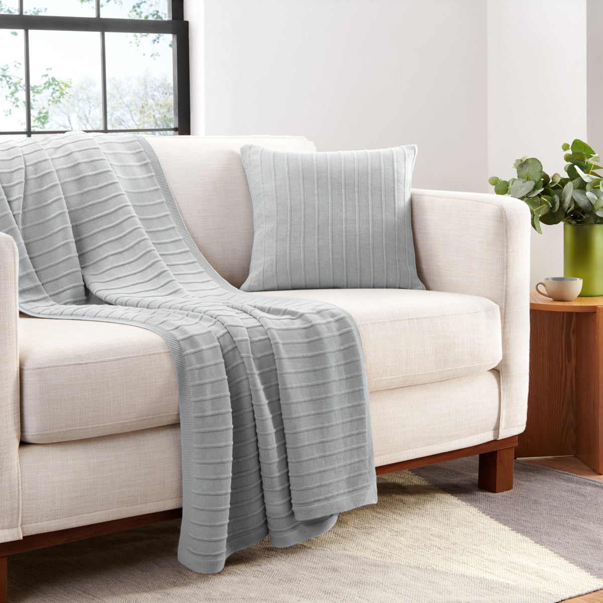 Organic Cotton Ribbed Knit Pillow Cover In Light Gray On Couch With Matching Throw