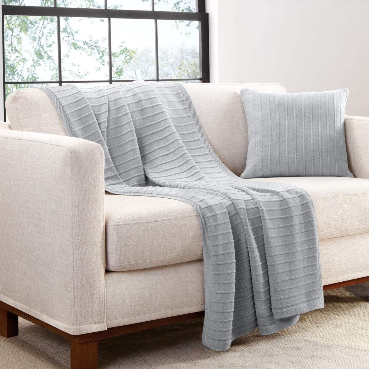 Organic Cotton Ribbed Knit Throw In Light Gray On Couch With Matching Pillow Cover