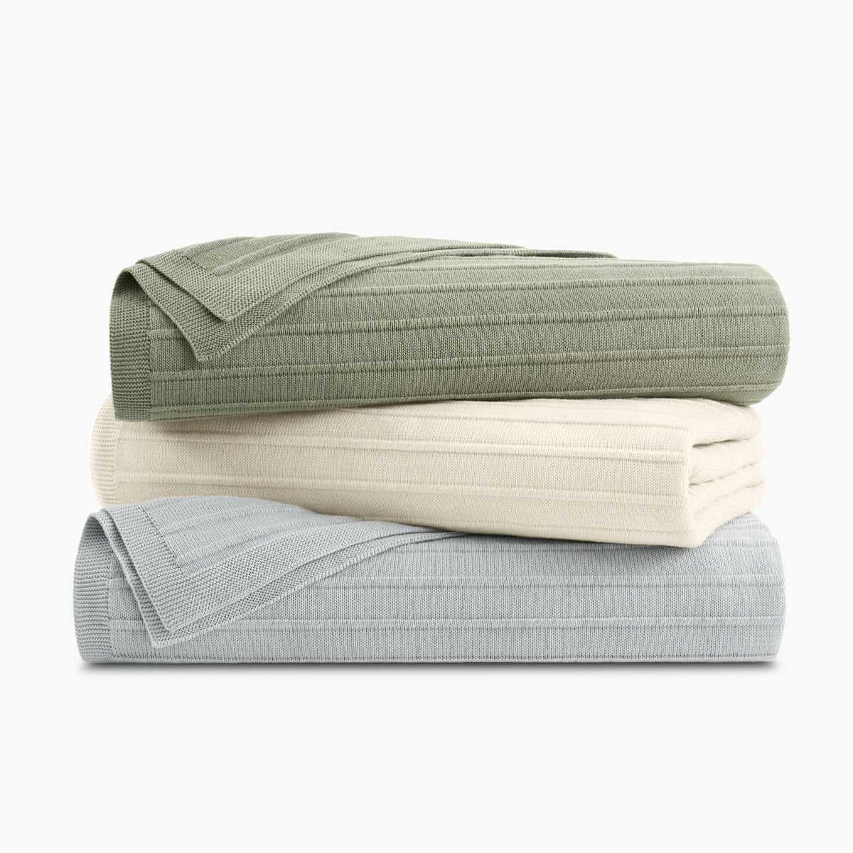 Stack Of Organic Cotton Ribbed Knit Throws In All Available Colors