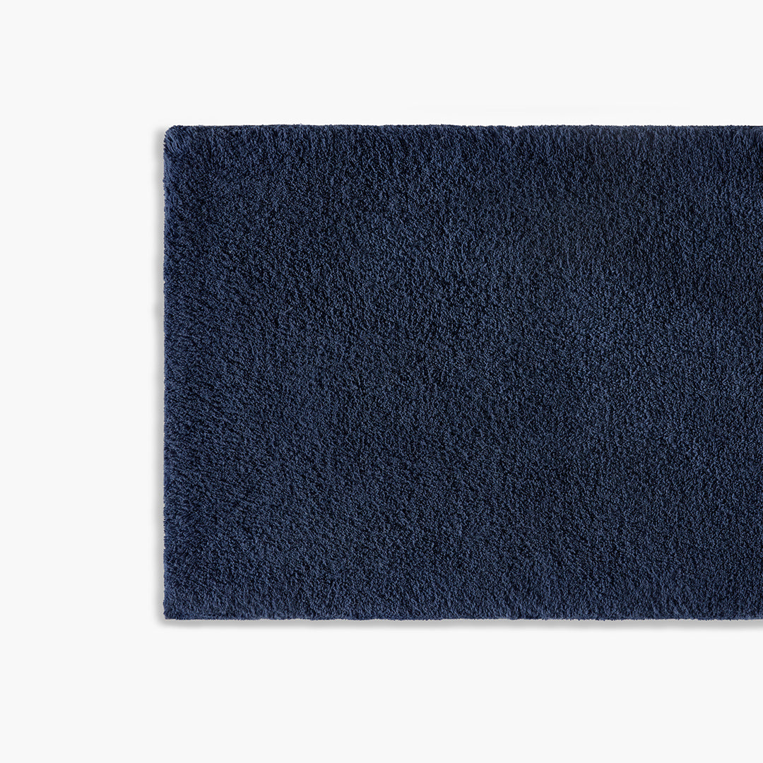 https://underthecanopy.com/cdn/shop/products/classic-organic-cotton-bath-rug-navy-blue-detail_1200x.jpg?v=1684770053