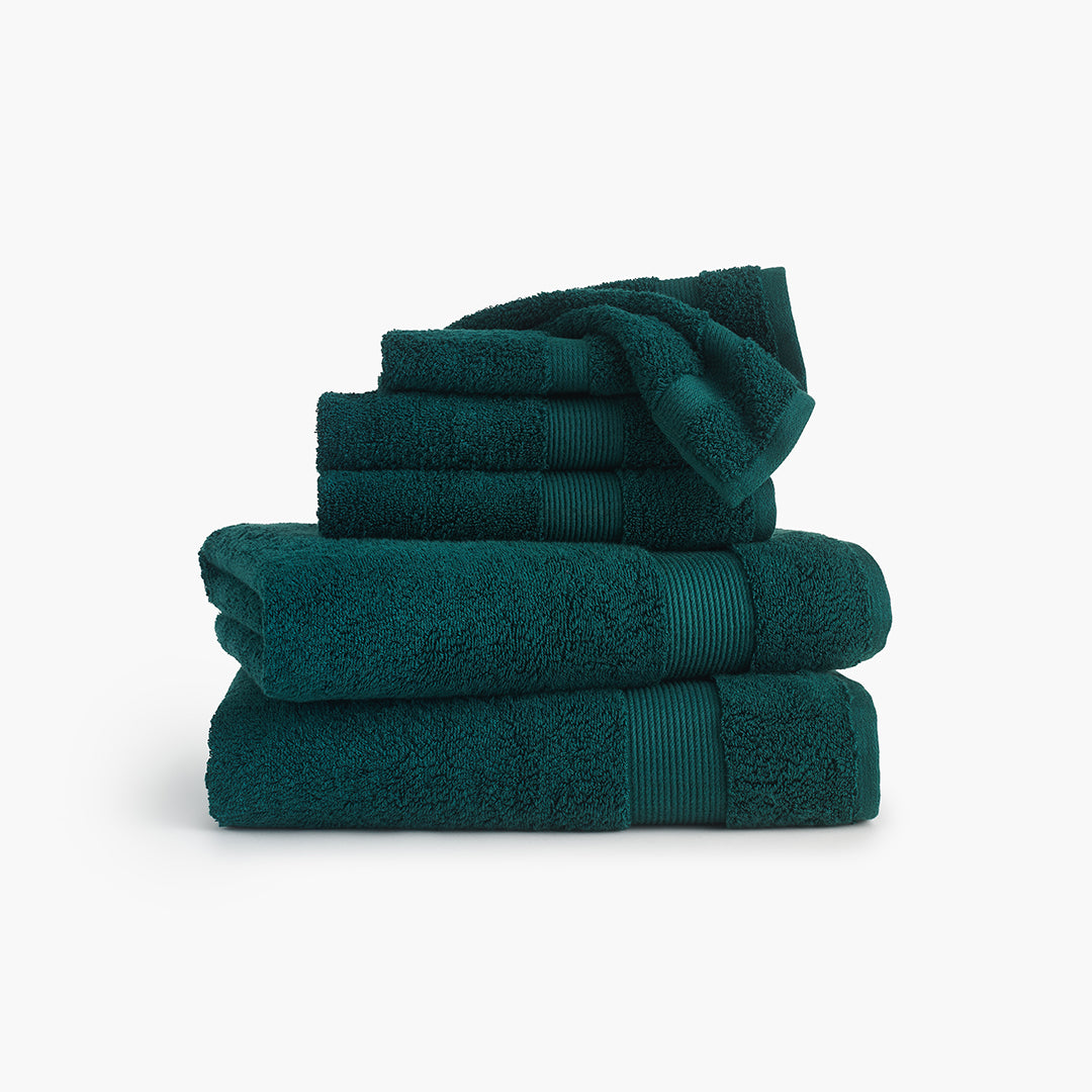 https://underthecanopy.com/cdn/shop/products/classic-organic-cotton-bath-towel-deep-teal-green-bundle.jpg?v=1684518009
