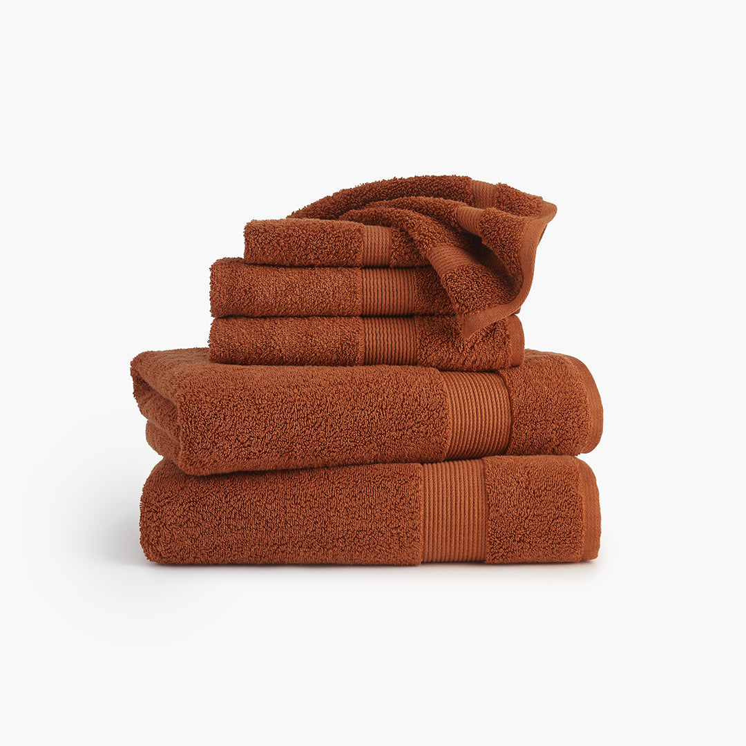 https://underthecanopy.com/cdn/shop/products/classic-organic-cotton-bath-towel-rust-red-bundle_1200x.jpg?v=1684437476