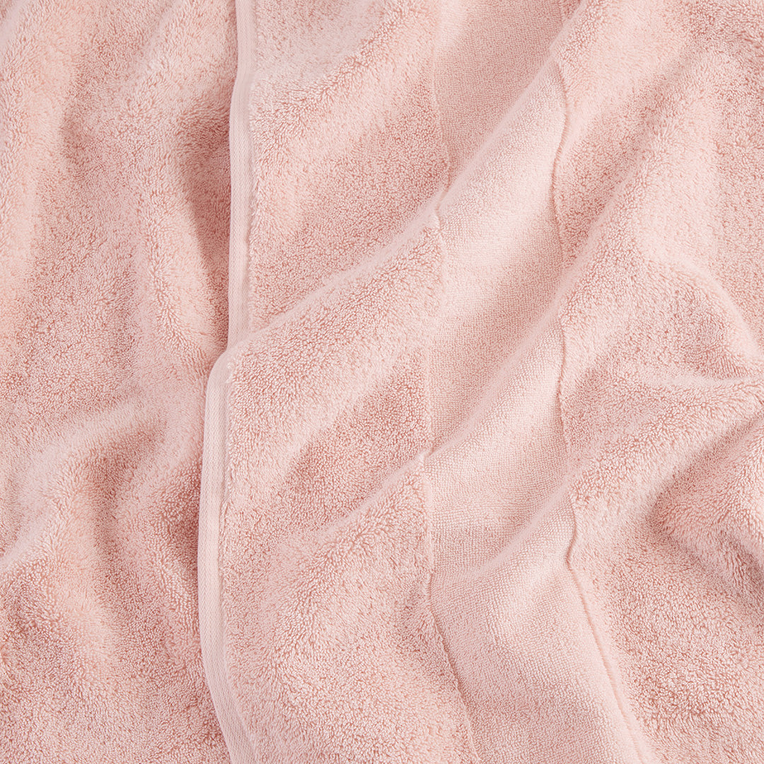 https://underthecanopy.com/cdn/shop/products/plush-organic-cotton-bath-towel-blush-pink-detail_1200x.jpg?v=1687377377