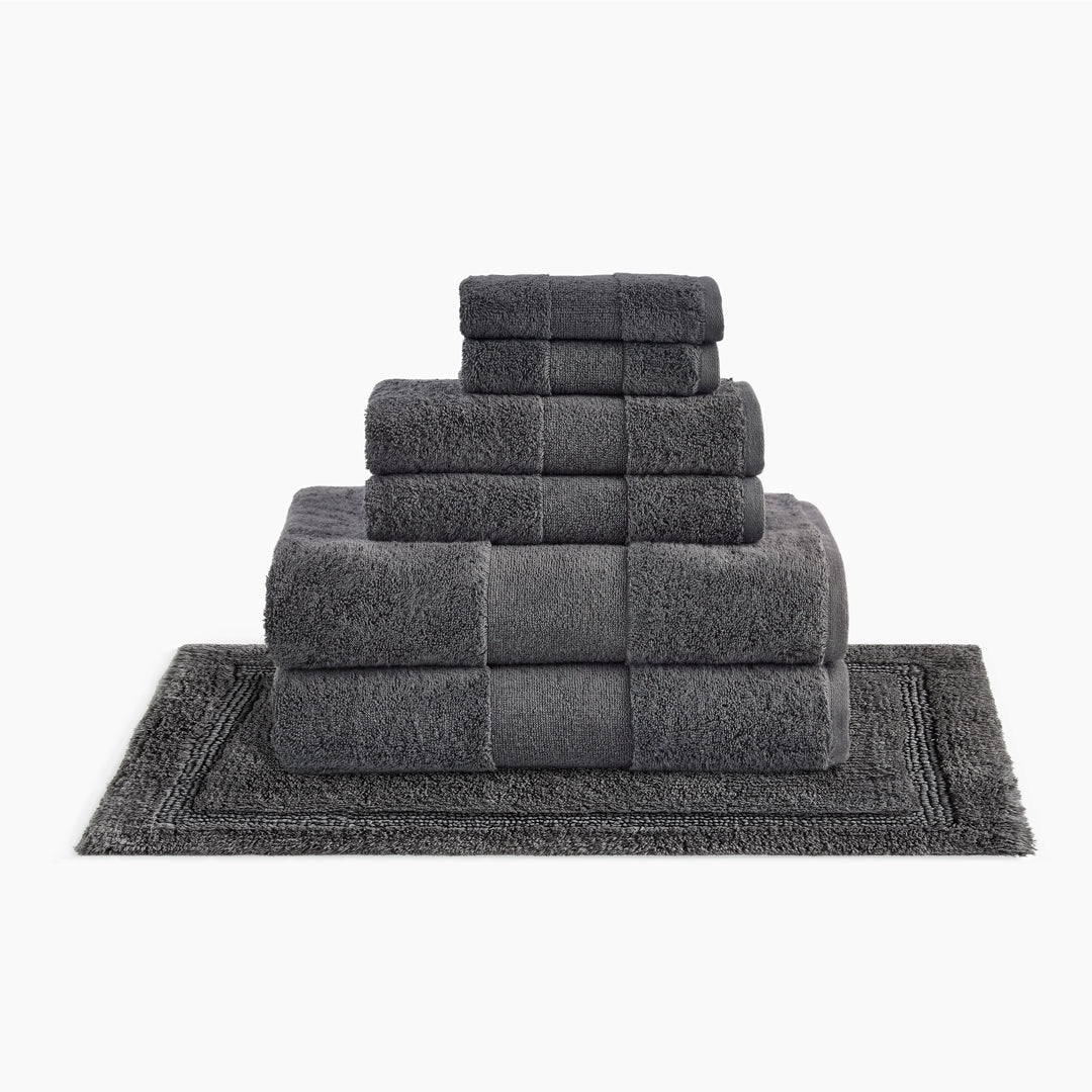 https://underthecanopy.com/cdn/shop/products/plush-organic-cotton-reversible-bath-rug-bundle-smoke-gray_1200x.jpg?v=1685459129