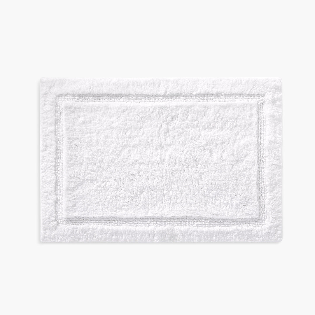 https://underthecanopy.com/cdn/shop/products/plush-organic-cotton-reversible-bath-rug-white-front_1200x.jpg?v=1685456889