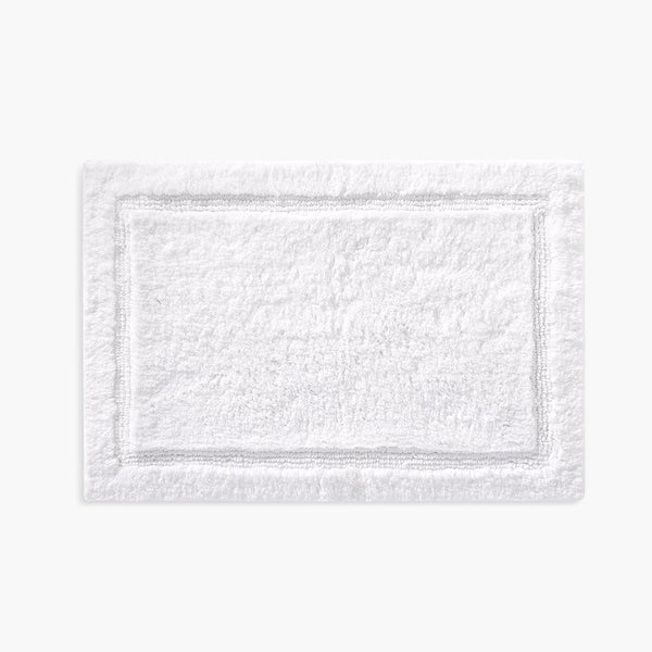 https://underthecanopy.com/cdn/shop/products/plush-organic-cotton-reversible-bath-rug-white-front_grande.jpg?v=1685456889